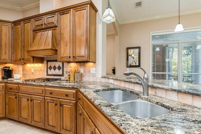 kitchen featuring brown cabinetry and a sink