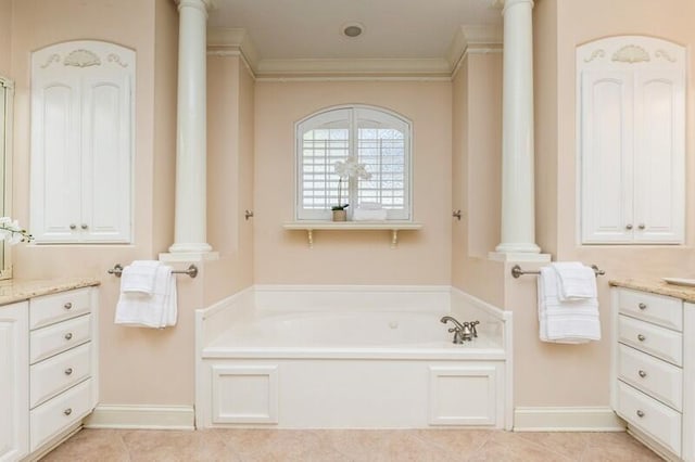 bathroom featuring decorative columns, a garden tub, vanity, and crown molding