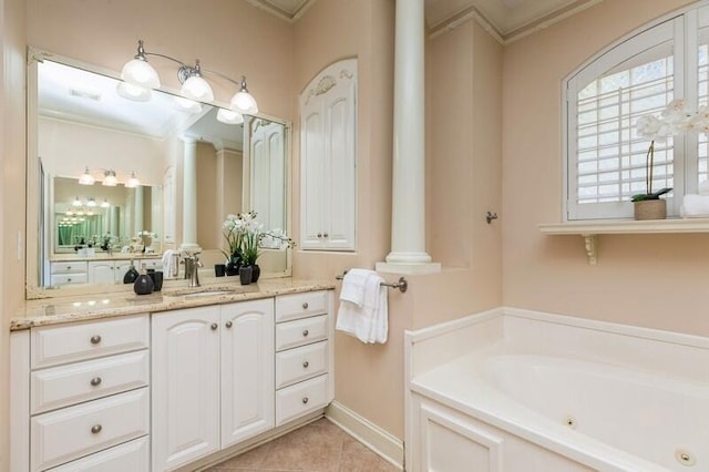 full bathroom with ornamental molding, decorative columns, tile patterned floors, a tub with jets, and vanity