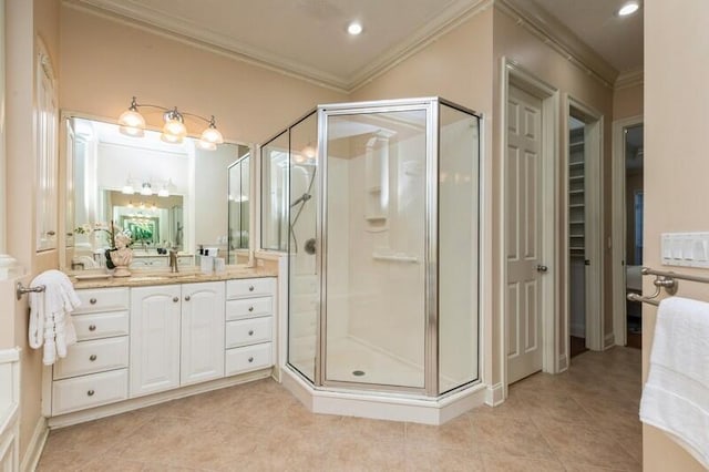 bathroom featuring tile patterned floors, a shower stall, vanity, and crown molding