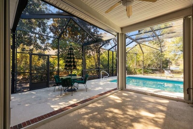 unfurnished sunroom featuring ceiling fan