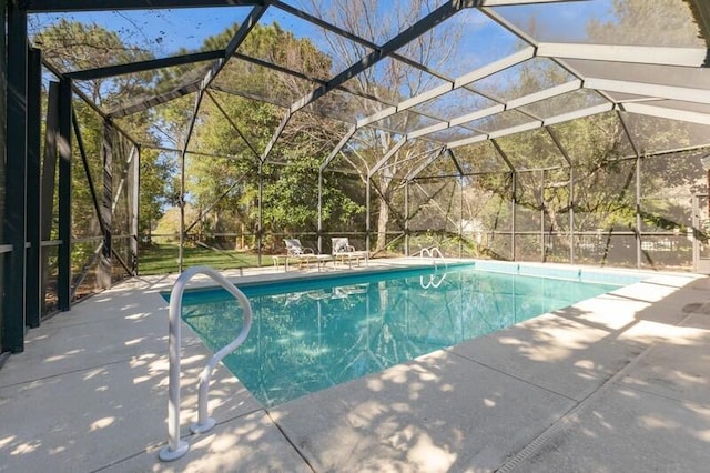 pool with glass enclosure and a patio