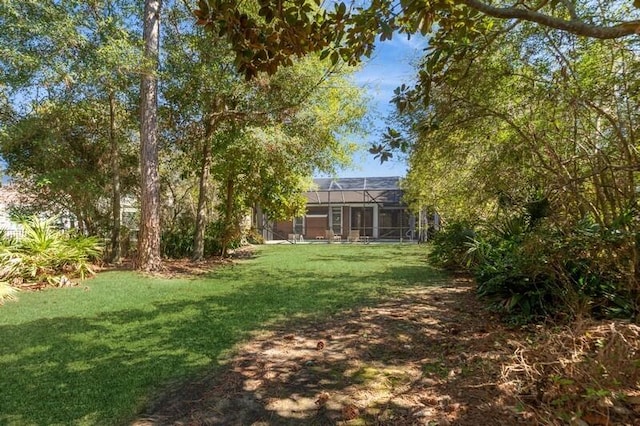 view of yard featuring glass enclosure