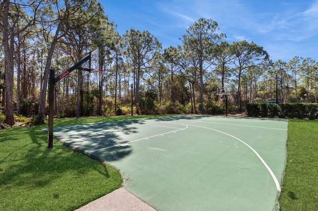 view of sport court with a lawn and community basketball court