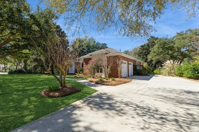 view of front of home featuring an attached garage, concrete driveway, and a front yard