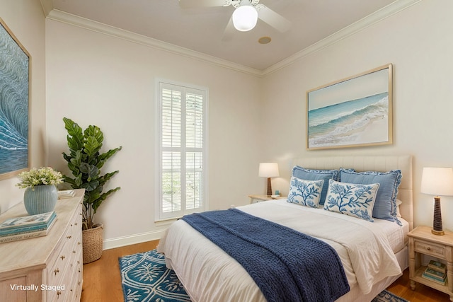 bedroom with multiple windows, baseboards, light wood finished floors, and ornamental molding