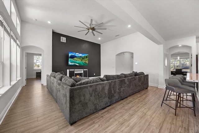 living room with light hardwood / wood-style flooring and ceiling fan