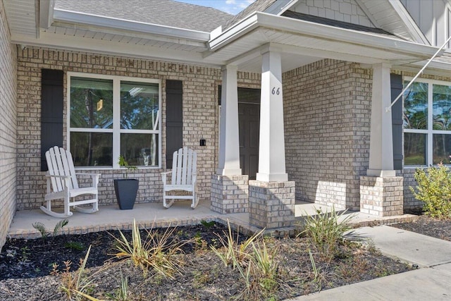 view of exterior entry featuring covered porch