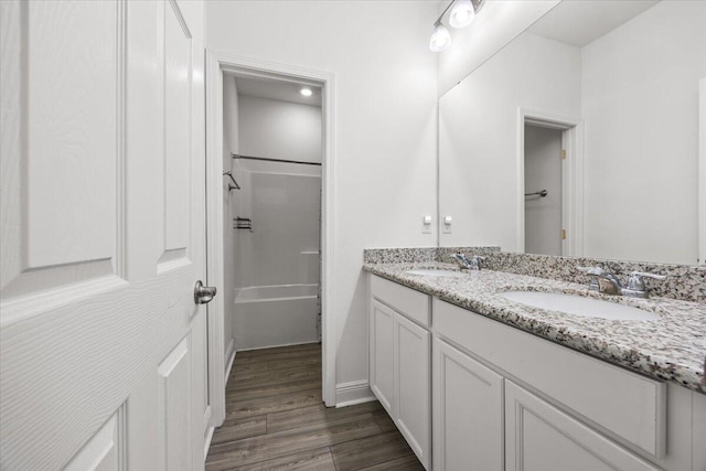 bathroom featuring shower / bath combination, vanity, and hardwood / wood-style flooring