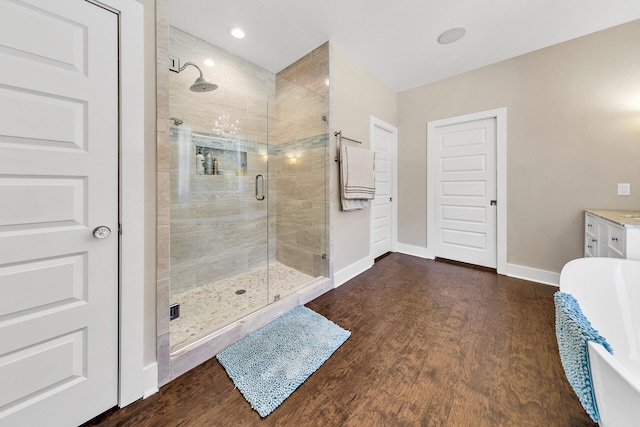 bathroom featuring hardwood / wood-style floors, vanity, and separate shower and tub