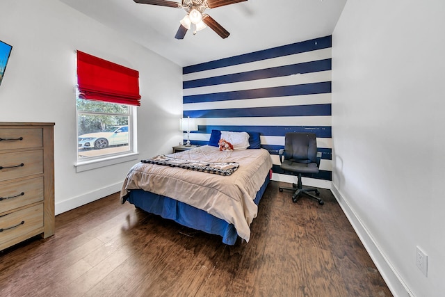 bedroom with dark hardwood / wood-style flooring and ceiling fan