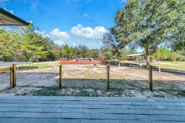 view of play area featuring a trampoline and a deck