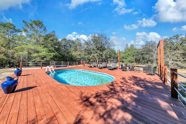 view of swimming pool featuring a wooden deck