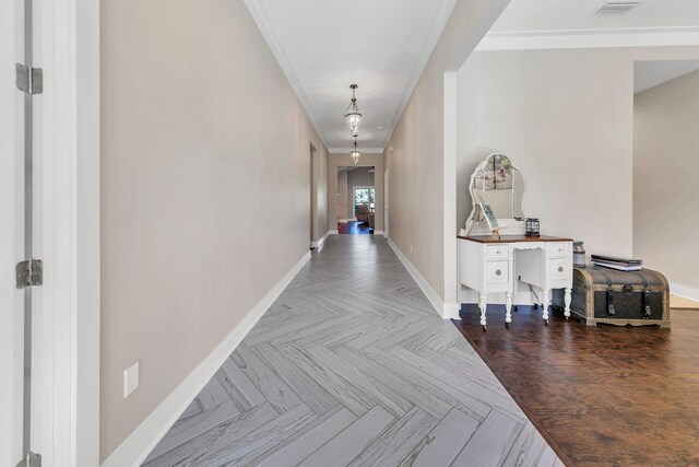 hall featuring parquet flooring and crown molding