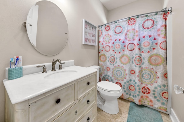 bathroom with curtained shower, vanity, and toilet