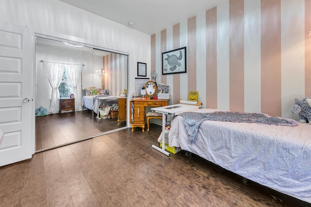 bedroom featuring dark hardwood / wood-style flooring and a closet