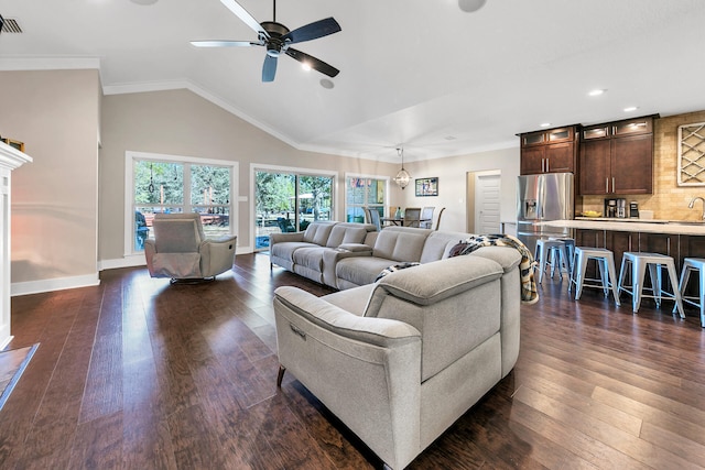 living room featuring ceiling fan, dark hardwood / wood-style flooring, lofted ceiling, and crown molding