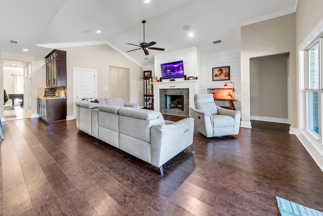 living room with dark hardwood / wood-style floors, vaulted ceiling, and plenty of natural light