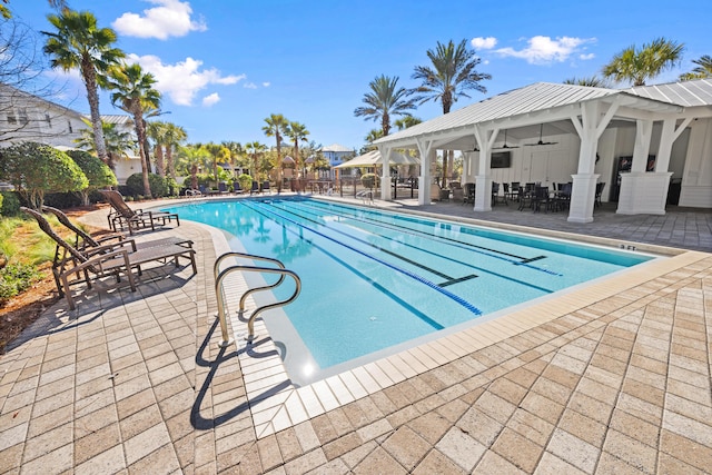 view of pool with ceiling fan, a gazebo, and a patio