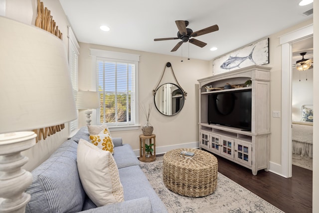 living room with ceiling fan and dark hardwood / wood-style floors