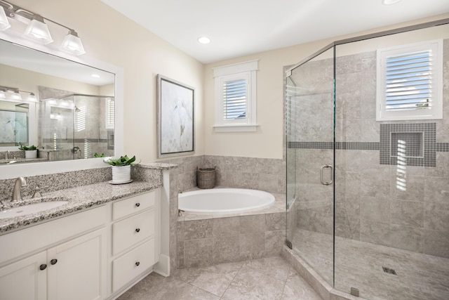 bathroom with vanity, tile patterned flooring, and shower with separate bathtub