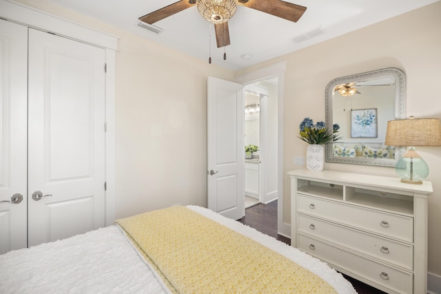 bedroom featuring ceiling fan, dark wood-type flooring, and a closet