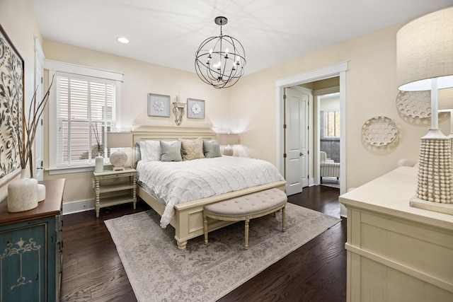 bedroom with dark wood-type flooring and a chandelier