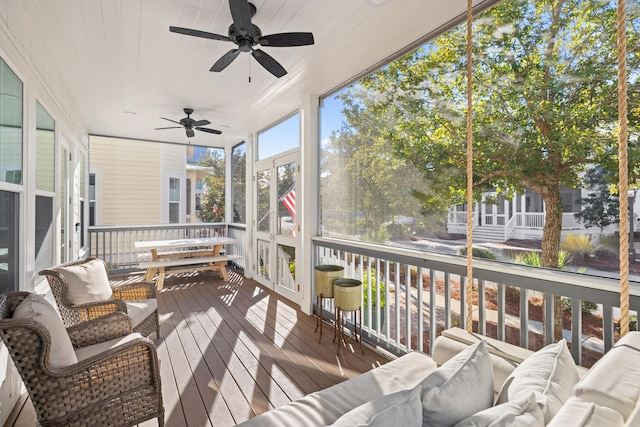 sunroom / solarium featuring ceiling fan