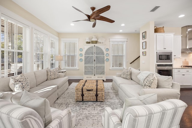 living room with ceiling fan and hardwood / wood-style flooring