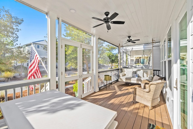 sunroom / solarium with ceiling fan, wood ceiling, and a wealth of natural light