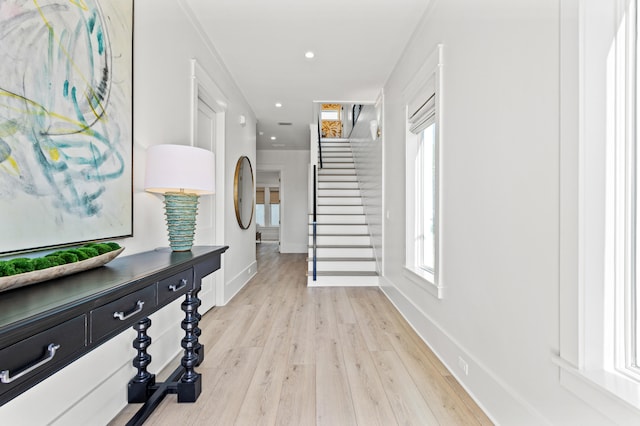 hall featuring light hardwood / wood-style floors and a wealth of natural light