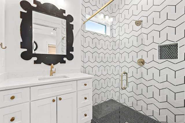 bathroom featuring vanity and a shower with door