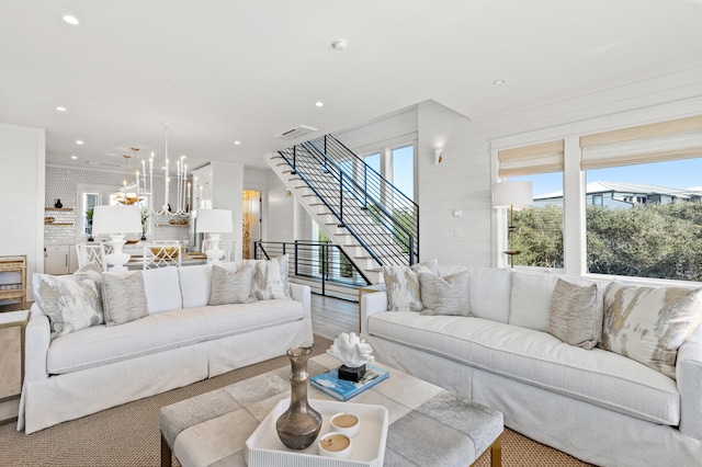 living room with wood-type flooring and a notable chandelier