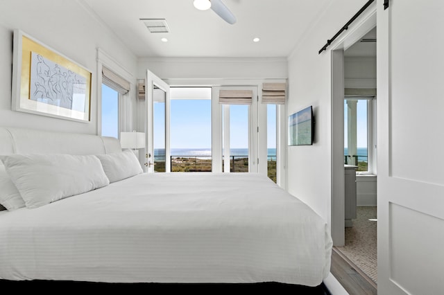 bedroom with access to exterior, ceiling fan, ornamental molding, and a barn door