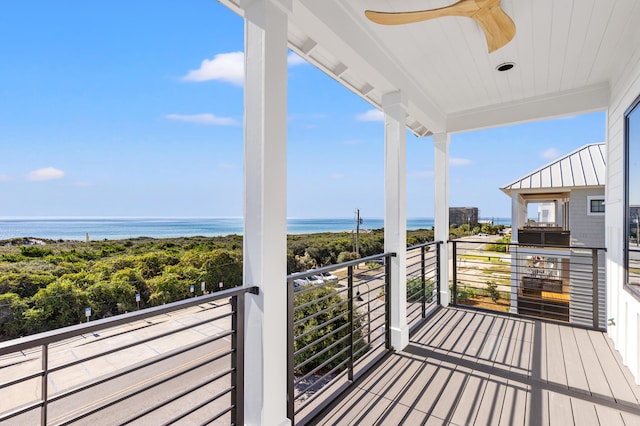 balcony featuring ceiling fan and a water view