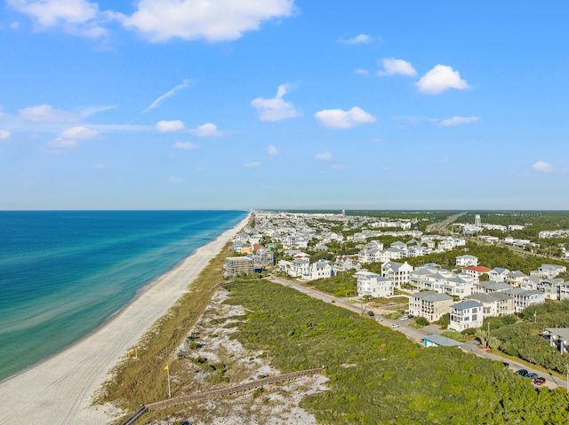 drone / aerial view with a water view and a beach view