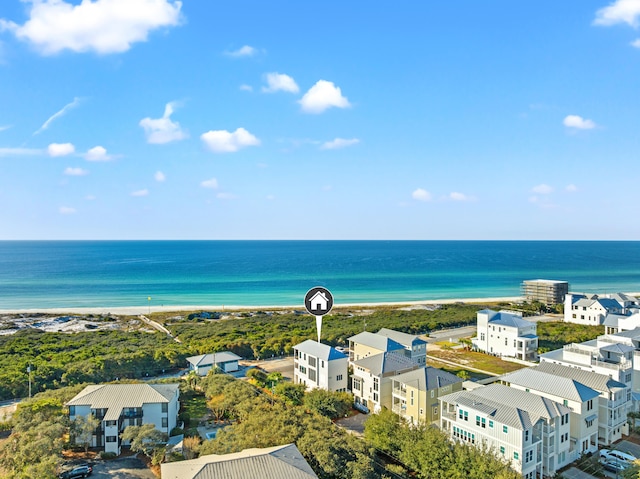 bird's eye view with a water view and a beach view