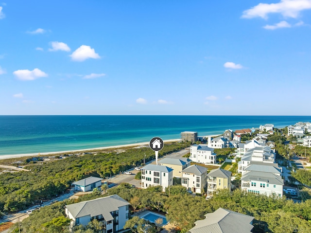 birds eye view of property with a water view and a beach view