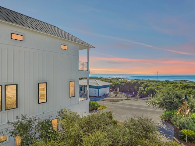 property exterior at dusk with a water view