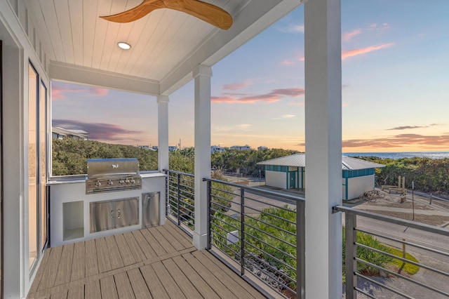 balcony at dusk with area for grilling