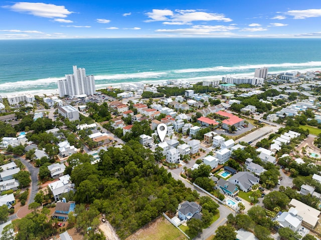 birds eye view of property with a water view and a view of the beach