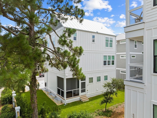 rear view of property with a yard