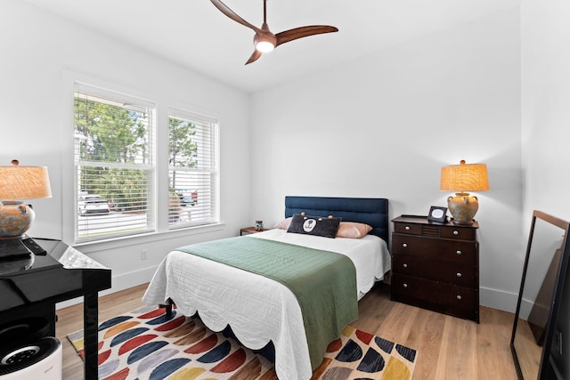 bedroom with light hardwood / wood-style floors and ceiling fan