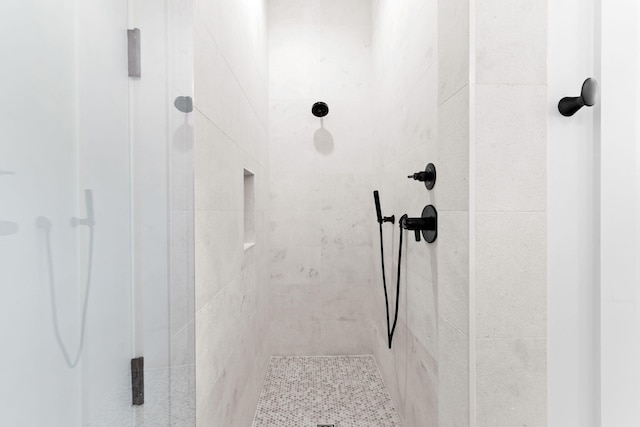 bathroom with tiled shower