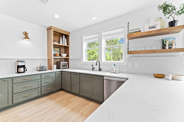 kitchen featuring decorative backsplash, sink, stainless steel dishwasher, and light wood-type flooring