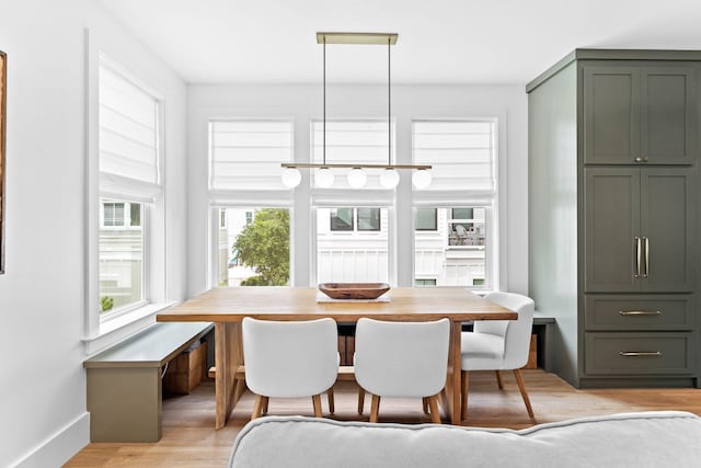 dining room featuring light wood-type flooring and breakfast area