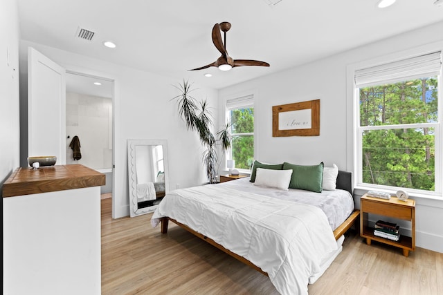 bedroom with multiple windows, ceiling fan, and light hardwood / wood-style floors