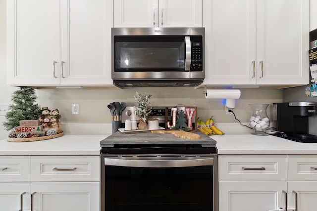 kitchen featuring white cabinets and light stone countertops