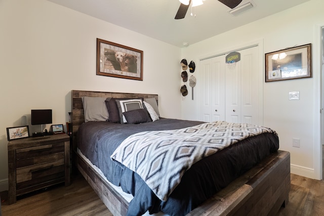 bedroom with ceiling fan, a closet, and dark wood-type flooring