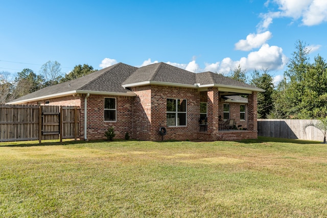 rear view of property with a yard